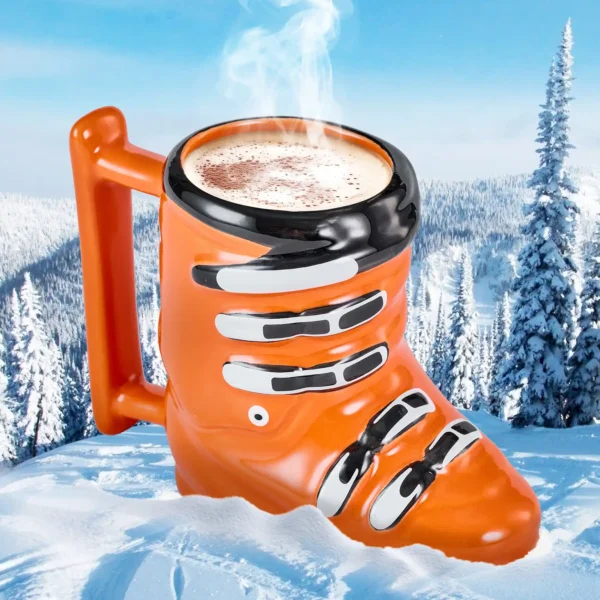 ski boot mug with a hot steaming cup of cocoa sitting on a snowy mountain side.