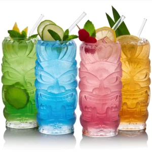 4 warrior tiki glasses on a pure white background, each with a tropical beverage.